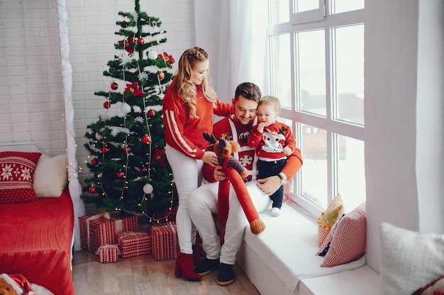 Cute young family sitting at home