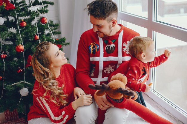 Cute young family sitting at home