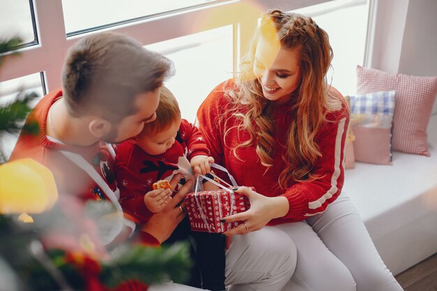 Cute young family sitting at home