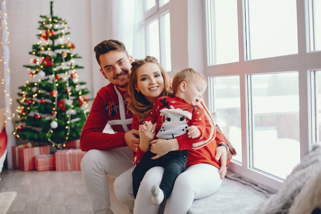 Cute young family sitting at home