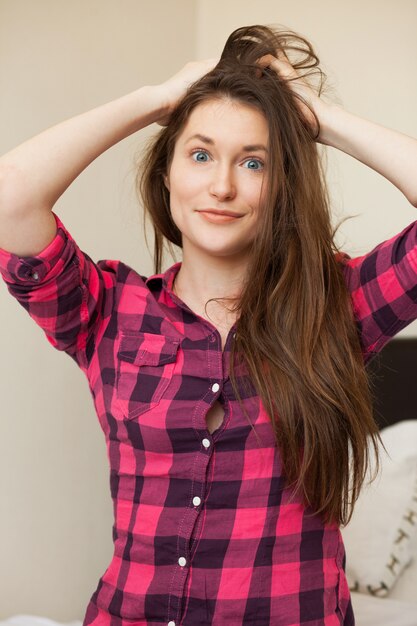 Cute young girl holding her hair