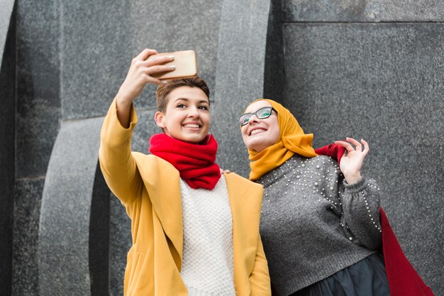 Cute young girls taking a selfie together