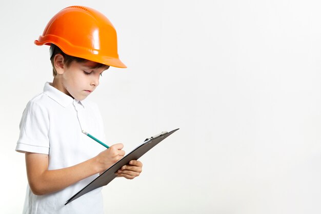 Cute young kid with helmet writting