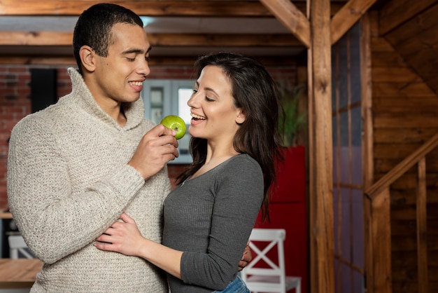 Cute young man and woman having an apple