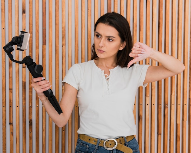 Cute young woman recoding a video