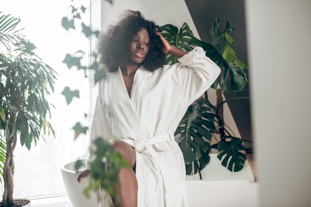 Cute young woman in a white bathrobe relaxing