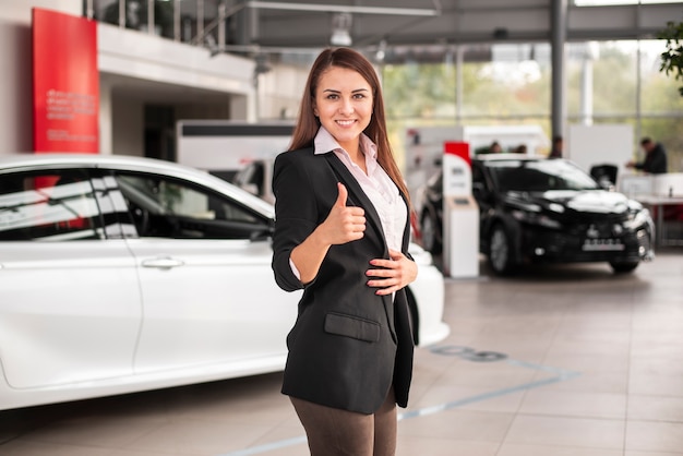 Cute young woman with thumb up