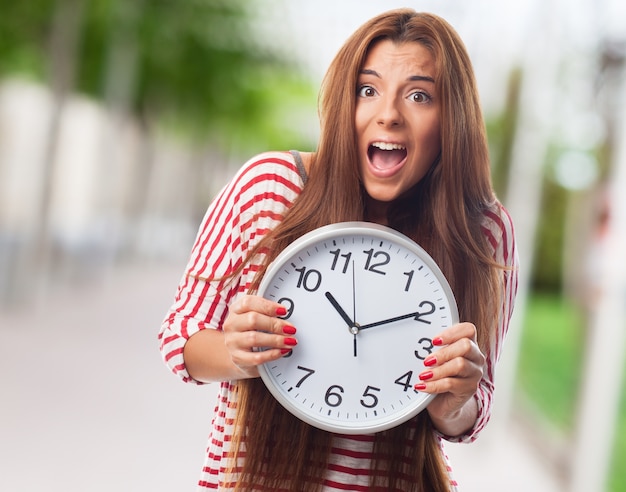 Free photo cutie holding clock in hands.