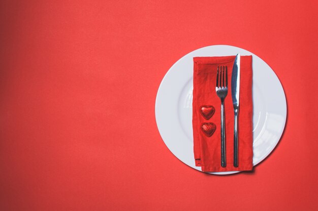 Cutlery with red hearts next to it