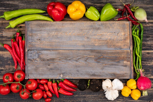 Cutting board surrounded by vegetables