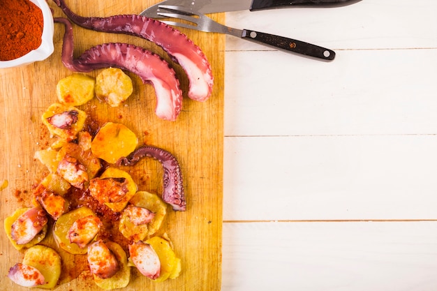 Cutting board with seafood on kitchen desktop