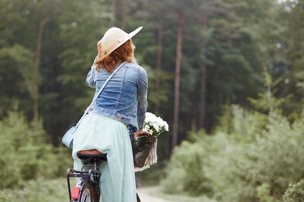 Cycling in the forest by fashion woman