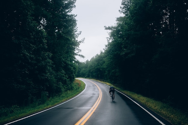 Cyclist man riding a bike on the road