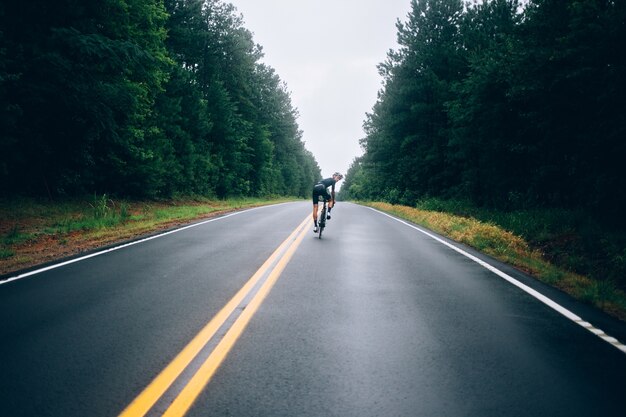 Cyclist man riding a bike on the road