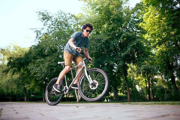 Cyclist riding in a city park.