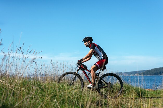 Cyclist riding his bike on the sea coast