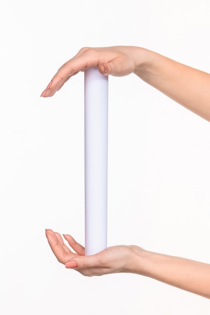 Free photo the cylinder female hands on white space