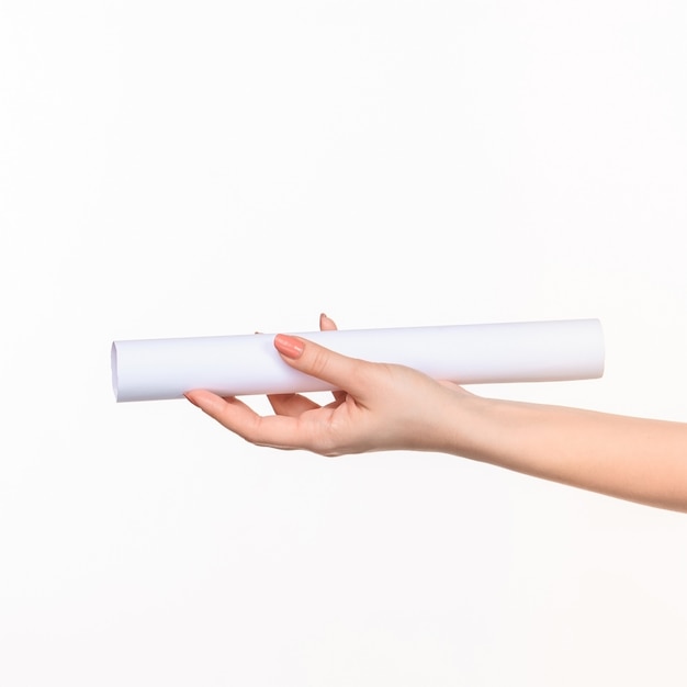 The cylinder in female hands on white wall