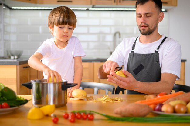 Dad and child peeling veggies