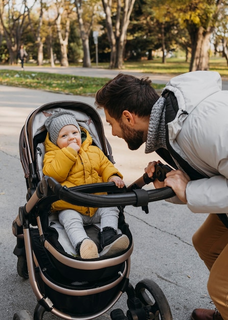 外のベビーカーでお父さんと子供