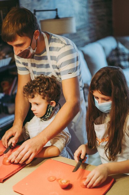 Dad and children cook pasta at a master class in gastronomy