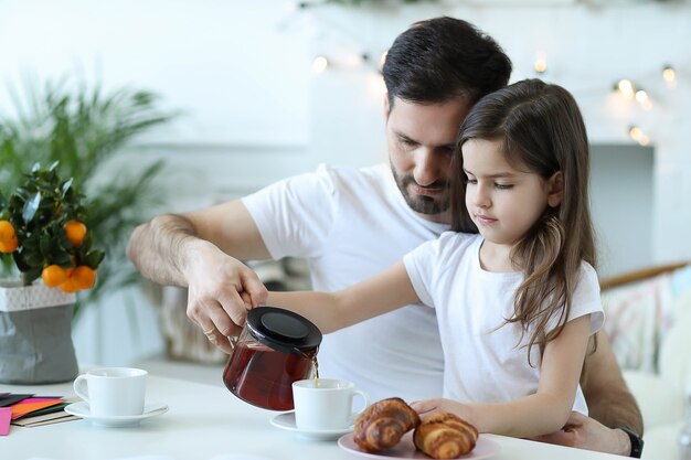 Dad and daughter having breakfast in the kitchen