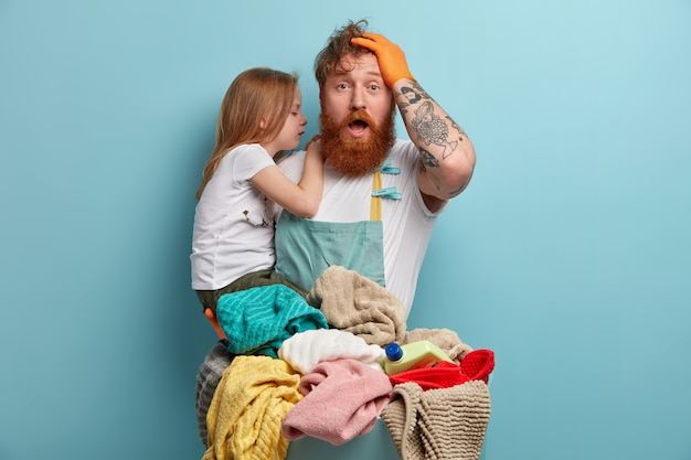 Dad and daughter prepare laundry for washing