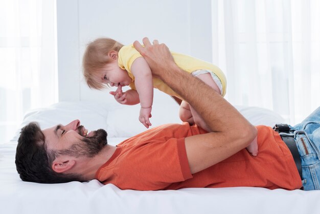 Dad holding baby and smiling