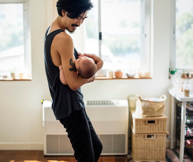 Dad holding the baby with love