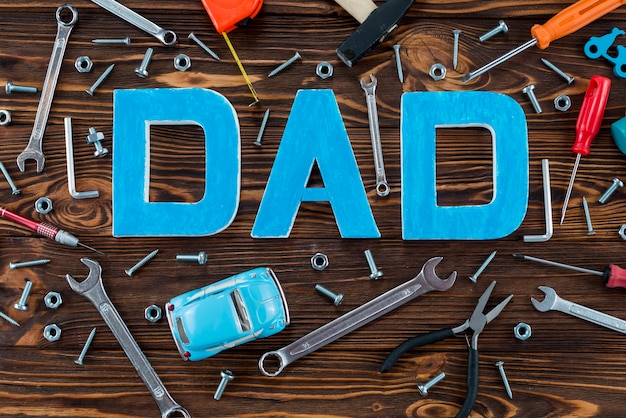 Free photo dad inscription with tools and toy car