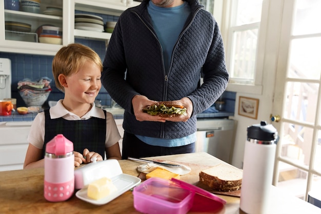 Dad preparing kid for first day of school