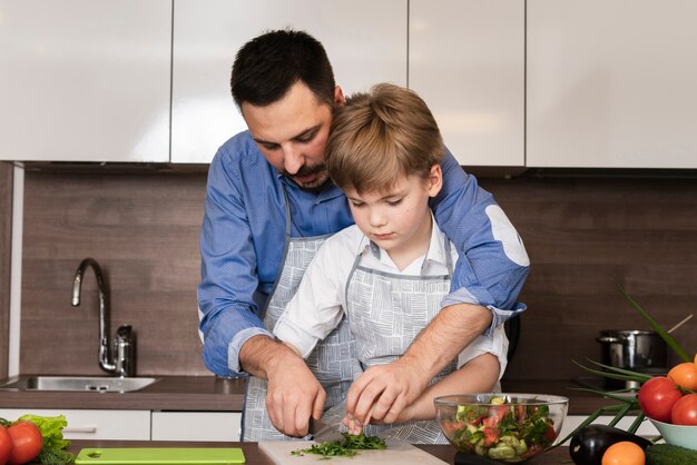 Dad and son cutting vegetables