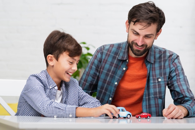 Dad and son playing with toy cars