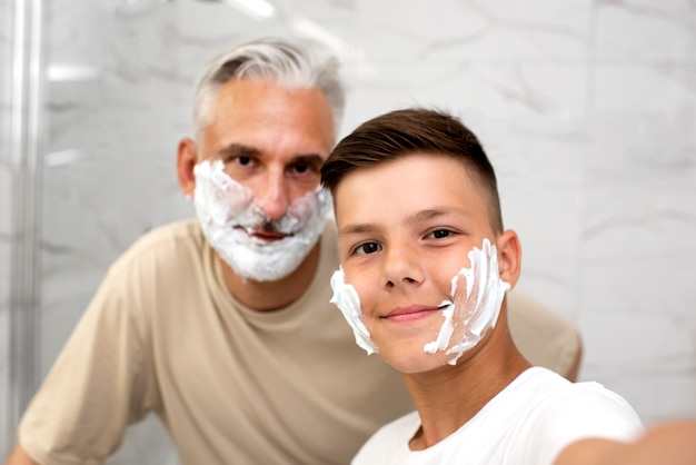 Free photo dad teaching his boy how to shave