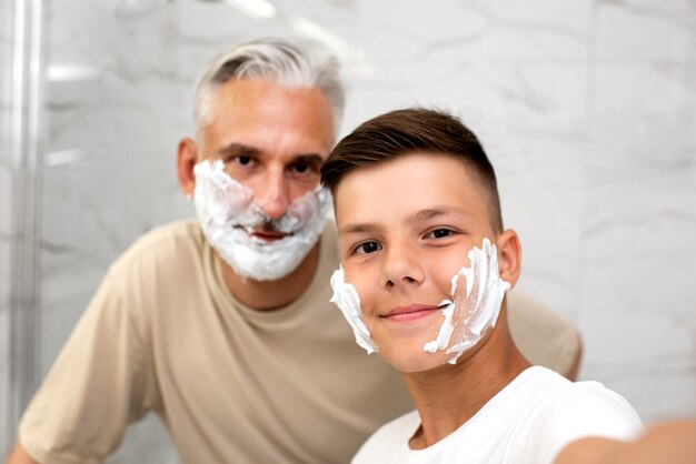 Dad teaching his boy how to shave