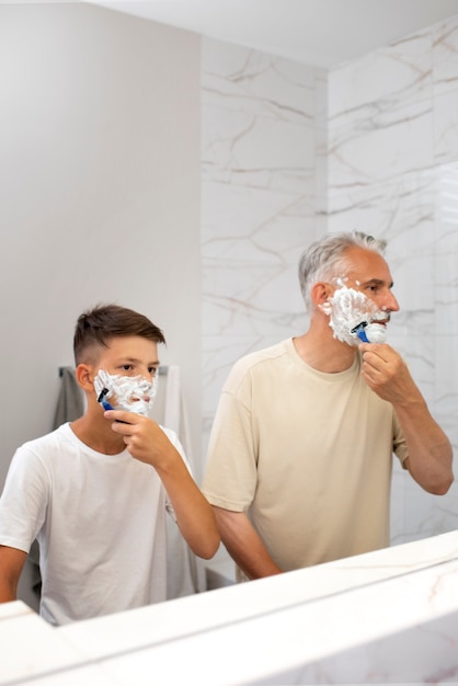 Free photo dad teaching his boy how to shave