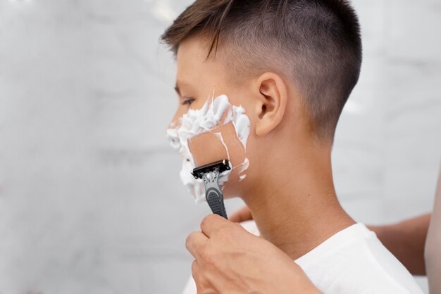 Dad teaching his boy how to shave