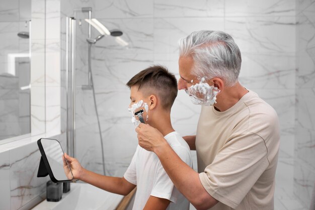 Dad teaching his boy how to shave