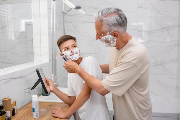 Dad teaching his boy how to shave
