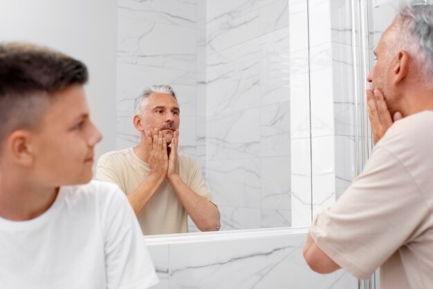 Dad teaching his boy how to shave