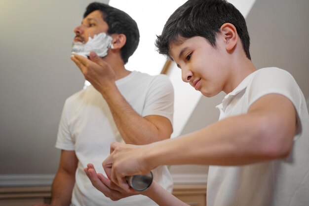 Dad teaching his boy how to shave