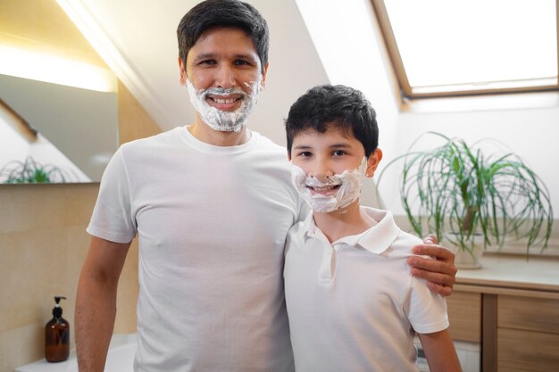 Dad teaching his boy how to shave