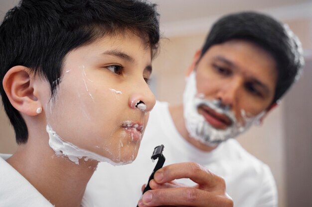 Dad teaching his boy how to shave