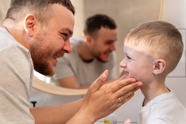 Dad teaching his son how to shave