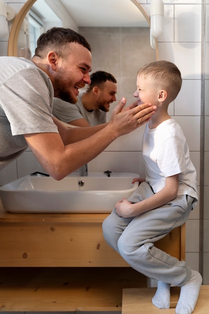 Dad teaching his son how to shave