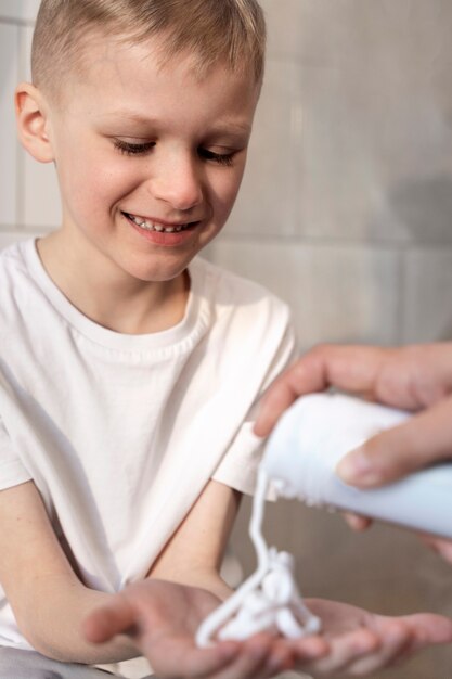 Dad teaching his son how to shave