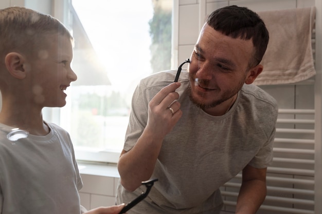 Dad teaching his son how to shave