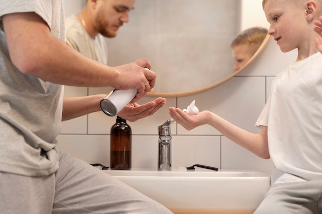 Dad teaching his son how to shave