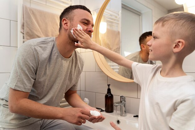 Dad teaching his son how to shave