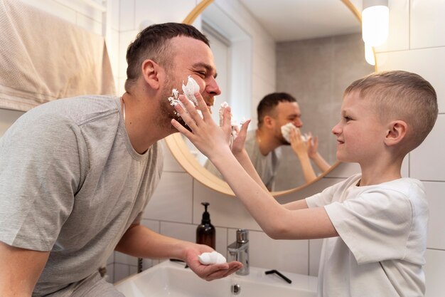 Dad teaching his son how to shave